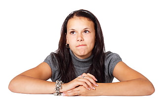 Young Woman with Pouting Expression on White Background