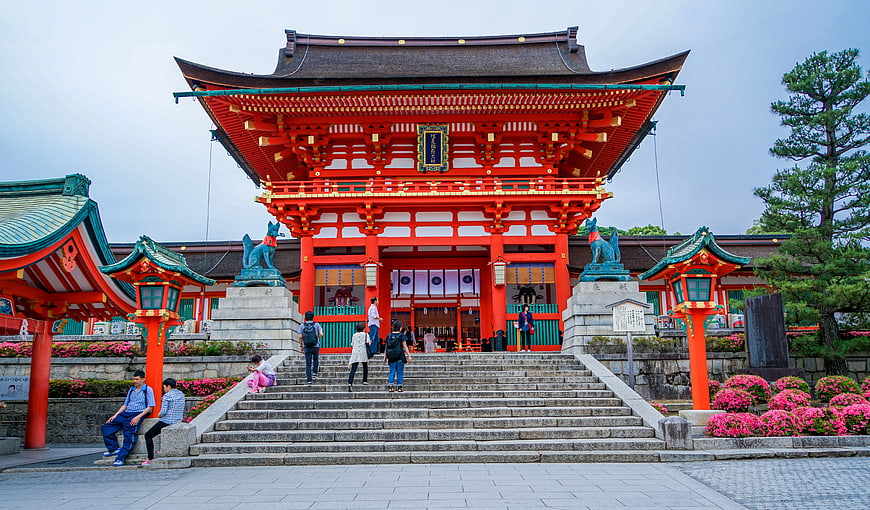 Vibrant Red Japanese Shrine Gate with Visitors