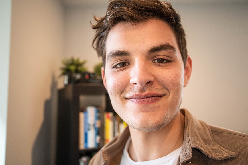 Close-up portrait of smiling young man indoors