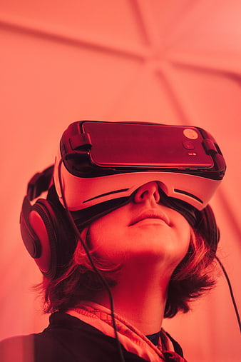 Person Wearing VR Headset and Headphones in Red Light