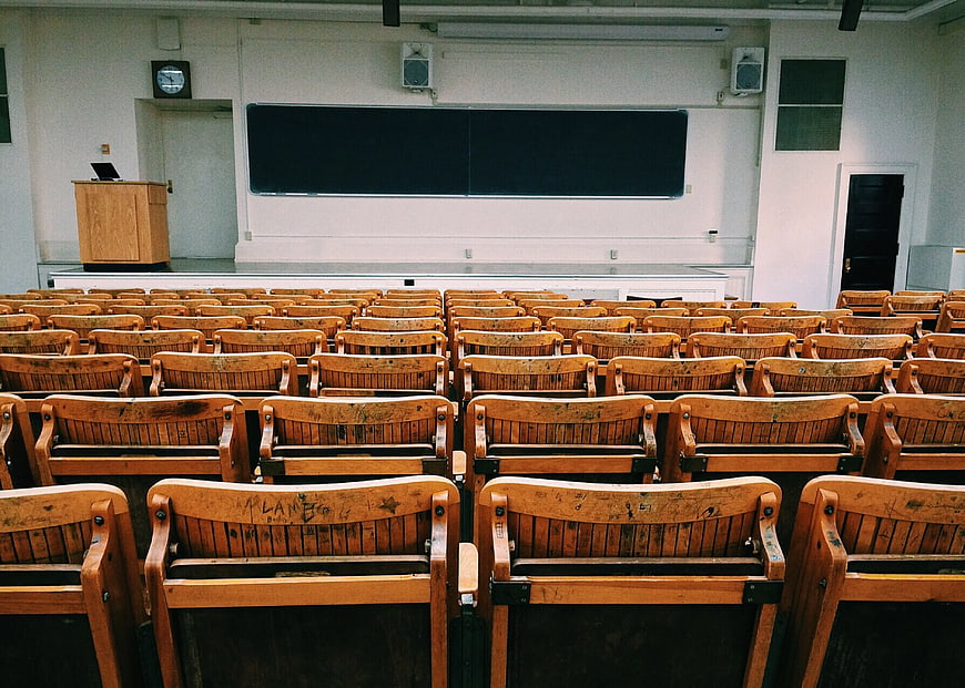 Empty Lecture Hall with Wooden Chairs and Blackboard