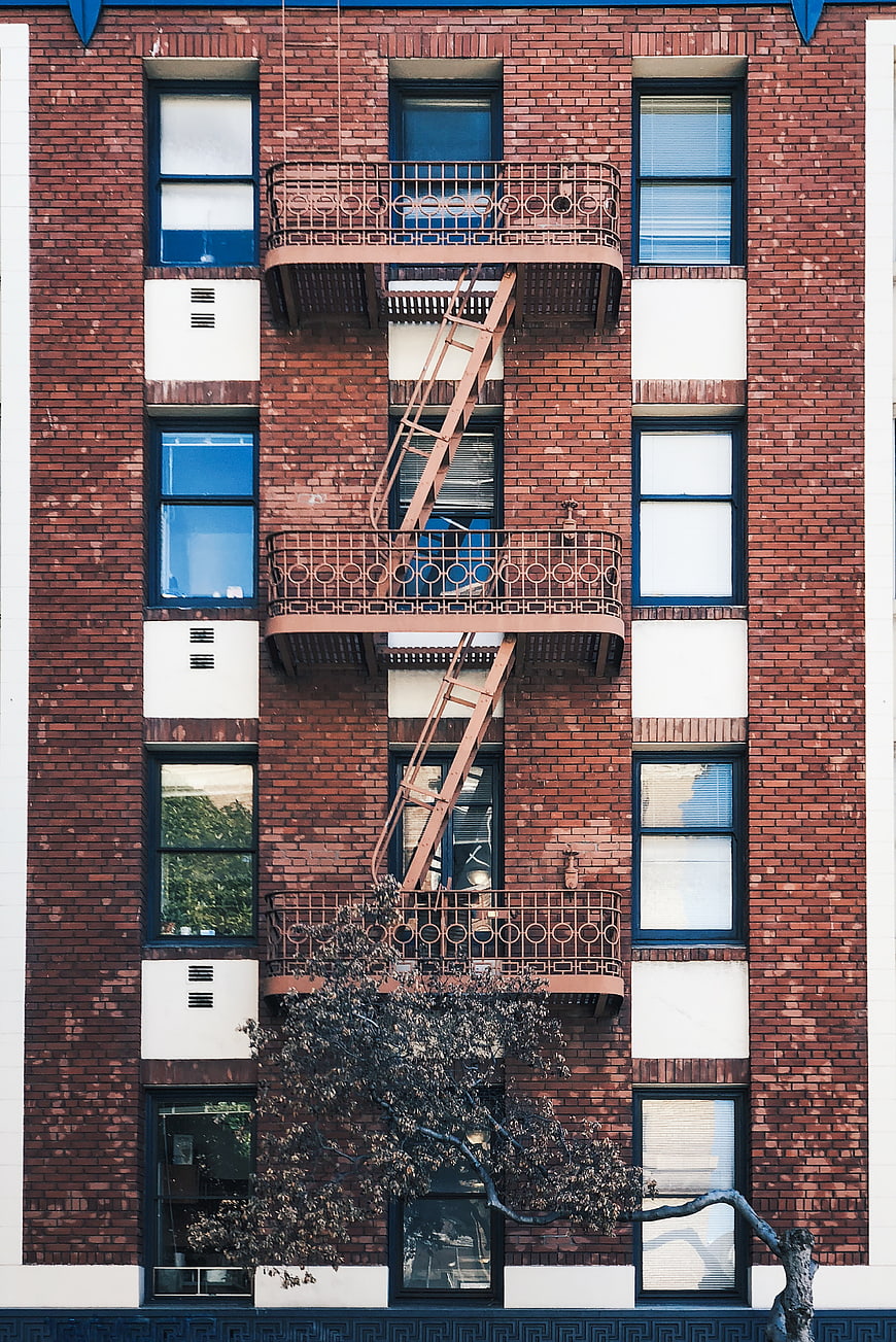 Red Brick Apartment Building Facade with Fire Escape