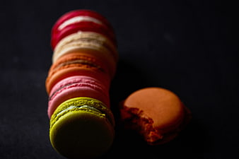 Stack of colorful macarons on dark background