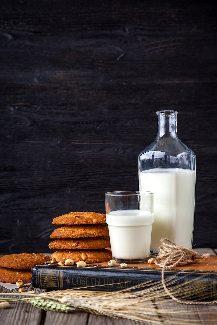 Glass Bottle of Milk and Cookies on Vintage Book