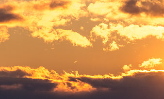 Dramatic Golden Sunset Sky with Fluffy Clouds