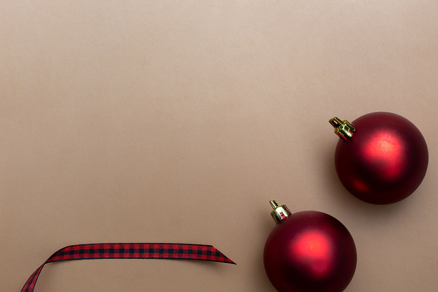 Minimal Christmas Ornaments and Ribbon on Beige Background