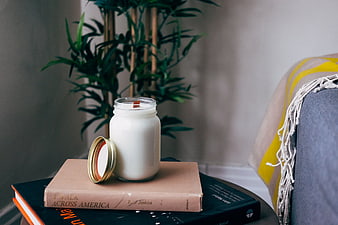 Cozy Home Interior with Candle, Books, and Plant