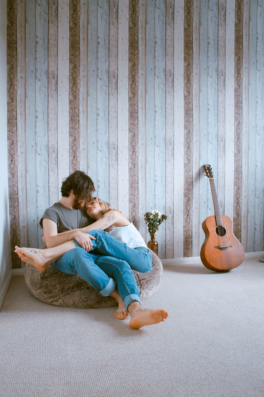 Couple Hugging on Beanbag Chair with Guitar