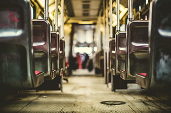 Empty Bus Interior with Rows of Seats and Blurred Background