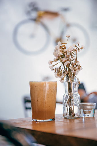 Healthy smoothie on wooden table with dried flowers