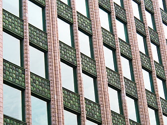 Modern building facade with green geometric tile patterns