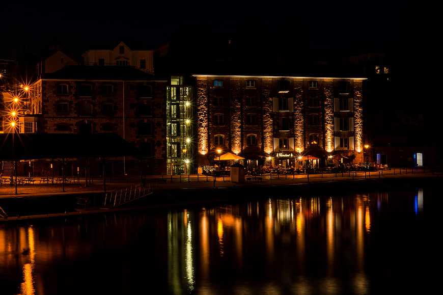 Night view of illuminated riverside restaurant in Exeter, UK