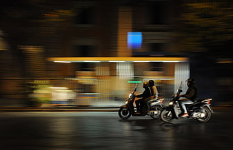 Night Panning Shot of Scooters on Urban Street