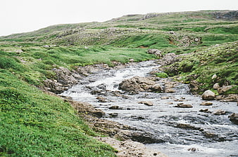 Flowing Mountain Stream Through Green Rocky Hills