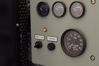 Close-up of vintage industrial control panel with gauges and switches