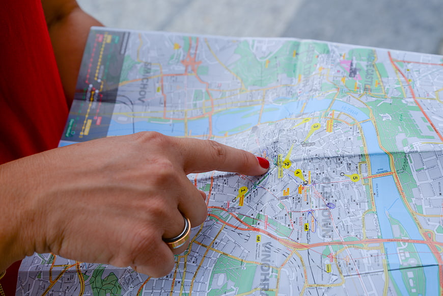 Woman pointing at location on city map