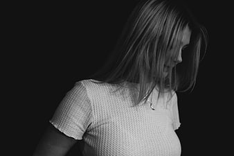 Black and white portrait of woman with hair covering face