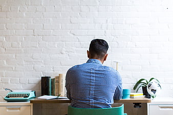 Man working at desk in modern home office with typewriter