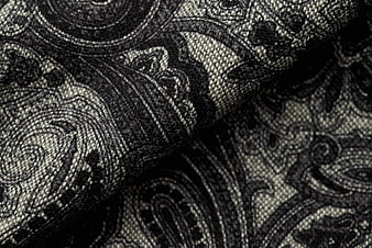 Close-up of black and white paisley woven fabric texture