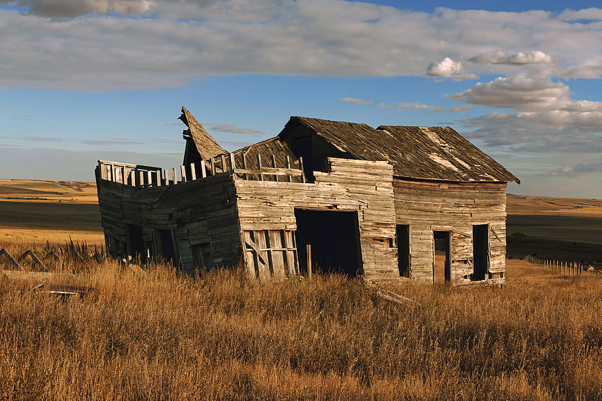 Abandoned Weathered Wooden Barn in Golden Prairie Field