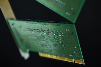 Close-up of green circuit board with gold connectors
