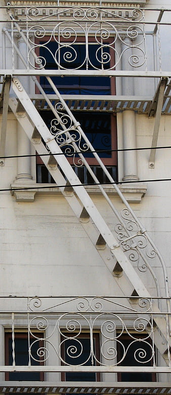 White Wrought Iron Fire Escape on Building Facade