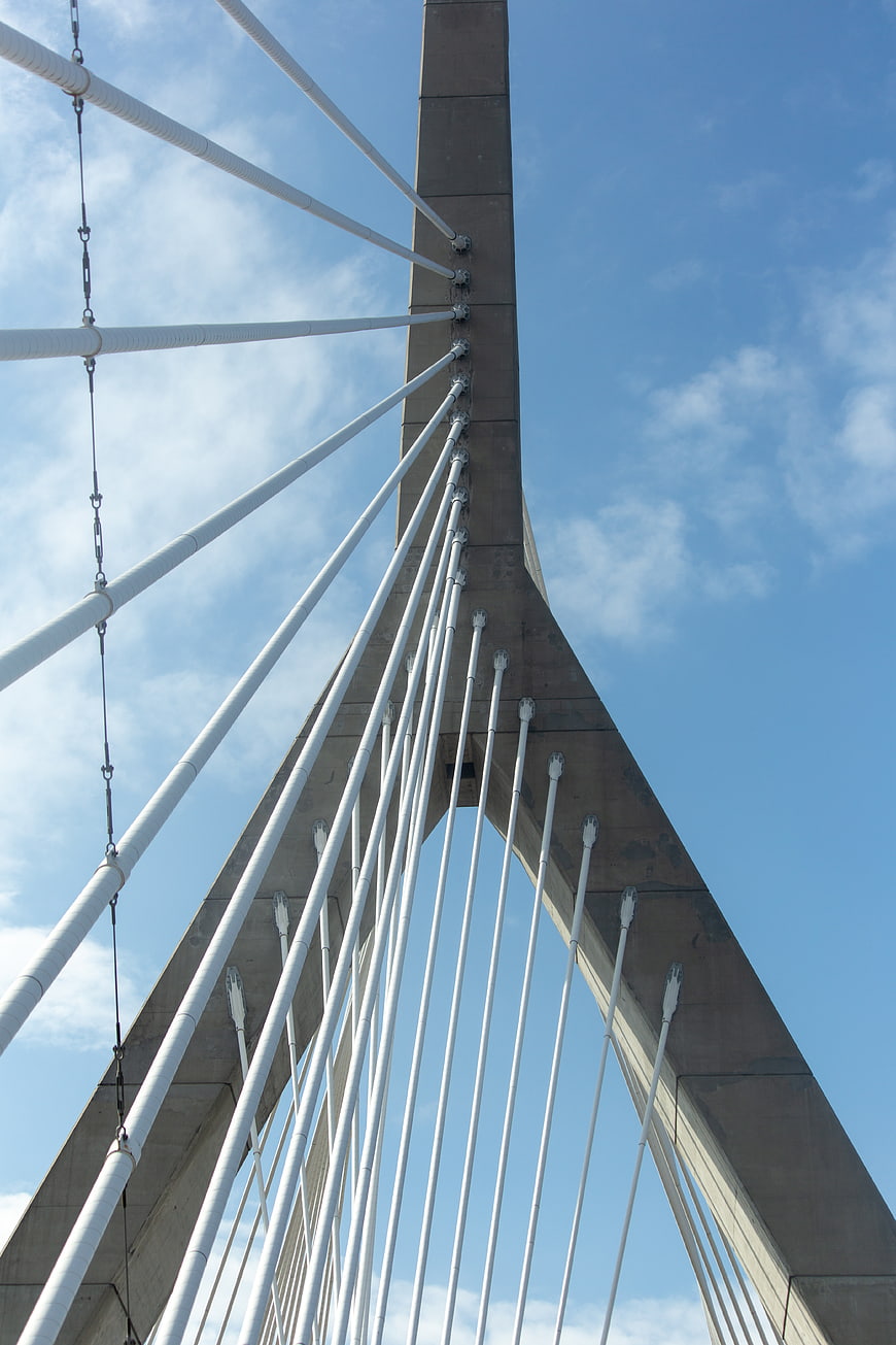 Low angle view of modern cable-stayed bridge tower against blue sky
