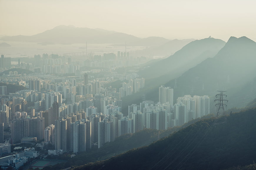 Hazy Aerial View of Hong Kong Cityscape and Mountains