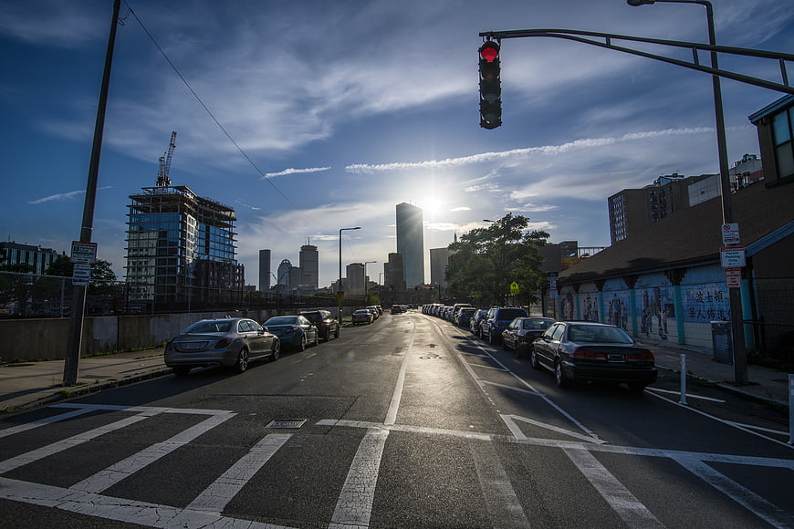 Urban Street View with Downtown Skyline and Sun Flare
