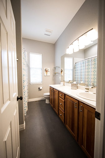 Modern bathroom interior with double vanity and wooden cabinets