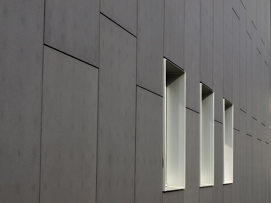 Modern Minimalist Gray Building Facade with Narrow Windows