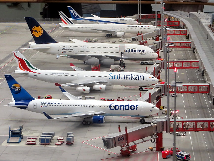Multiple Airline Planes Parked at Airport Gates