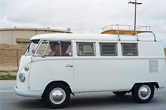 Vintage White Volkswagen Bus Driving on Highway