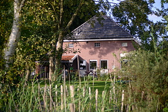 Red brick Dutch farmhouse in green countryside