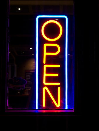 Vertical Neon Open Sign in Window at Night