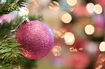 Close-up of Glittery Pink Christmas Bauble on Tree