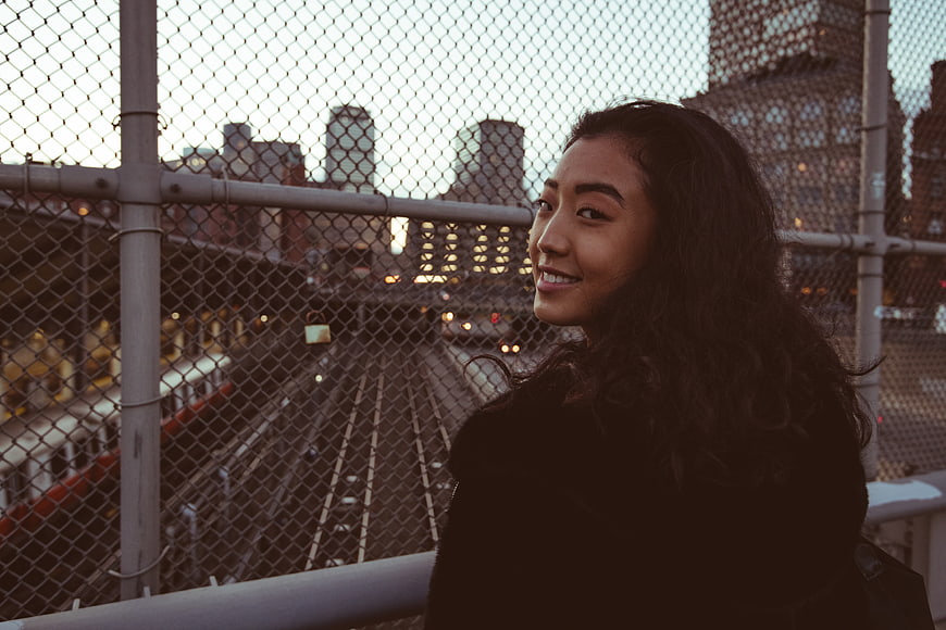 Smiling Asian Woman Portrait on Urban Bridge at Dusk