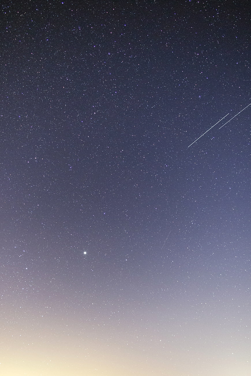 Starry Night Sky with Shooting Stars and Gradient Horizon