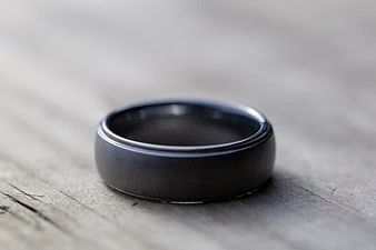 Black Tungsten Wedding Band on Rustic Wood Surface