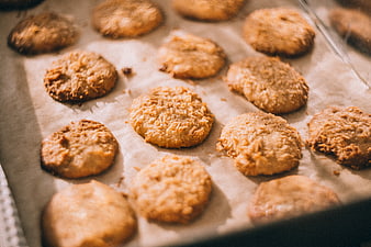 Freshly baked coconut cookies on parchment paper baking sheet