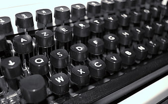 Close-up of vintage typewriter keys in black and white