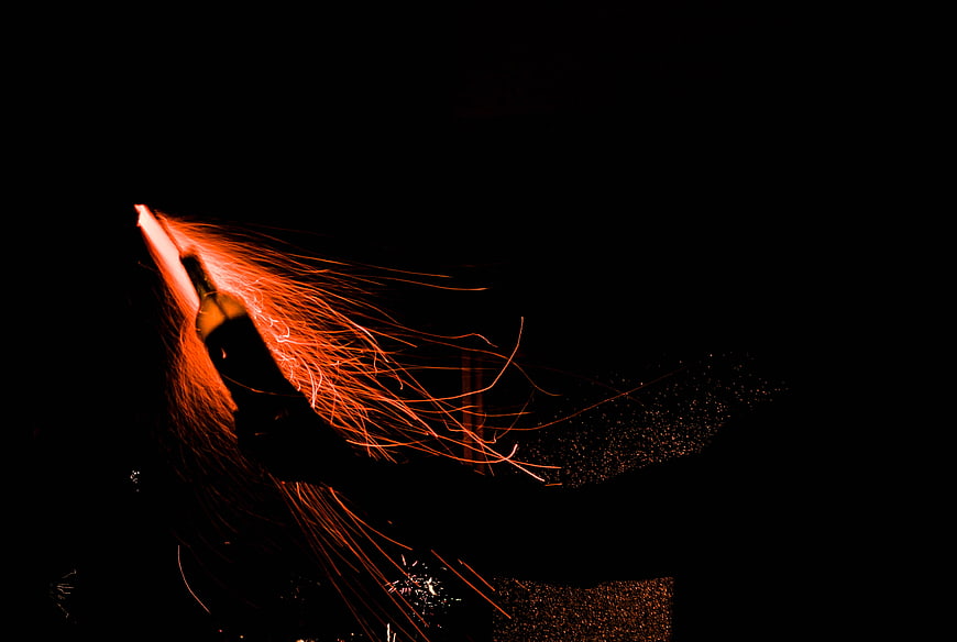 Sparks Flying from a Bottle in the Dark Night