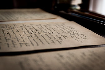Vintage handwritten letters on aged paper with shallow depth of field