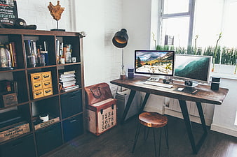 Modern Home Office Workspace with Dual Monitors and Bookshelf