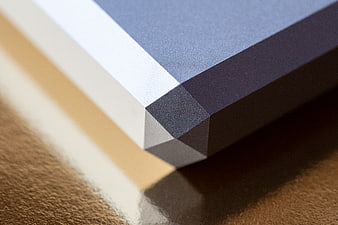 Close-up of geometric layered paper corner with blue and beige tones