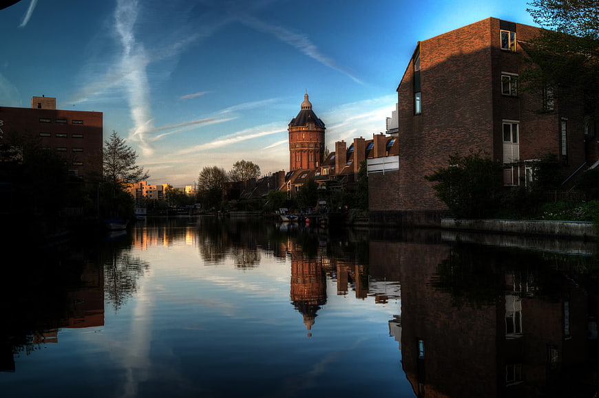Serene Canal Reflection of Historic Water Tower at Sunset