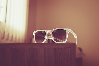 White Sunglasses on Wooden Surface with Vintage Filter