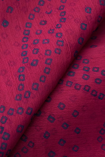 Close-up of red fabric with blue geometric pattern