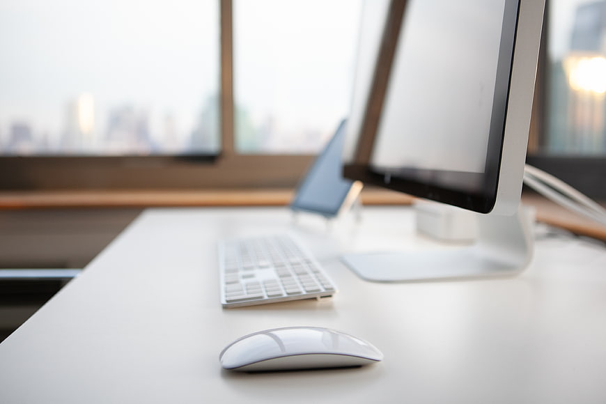 Modern minimalist white office desk with computer and city view