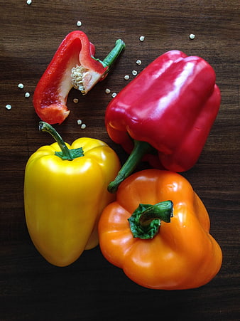 Colorful Bell Peppers on Dark Wood Background